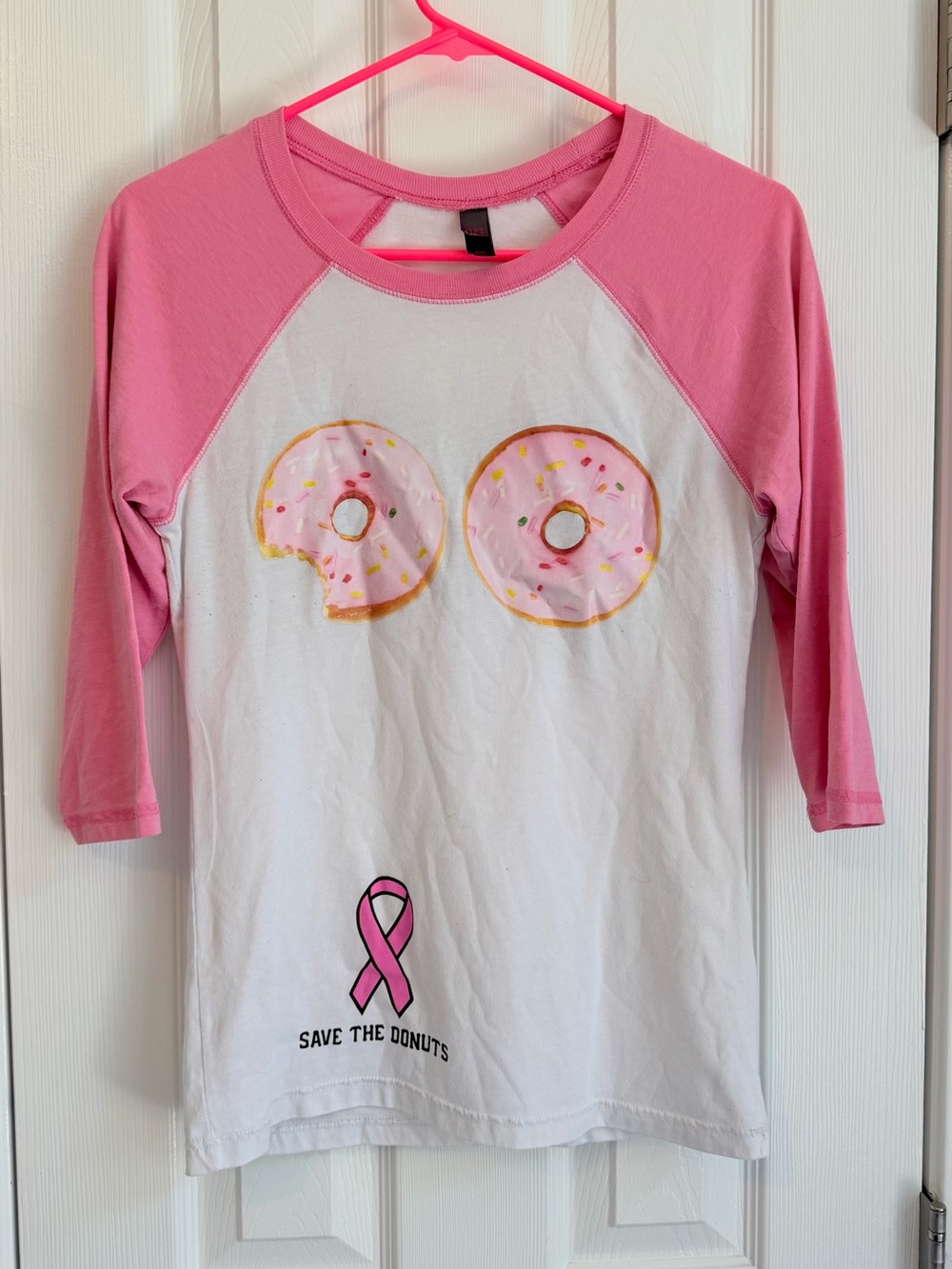 SLO DO CO Breast Cancer Pink and White Raglan Long Sleeve Tee with Donut Graphic